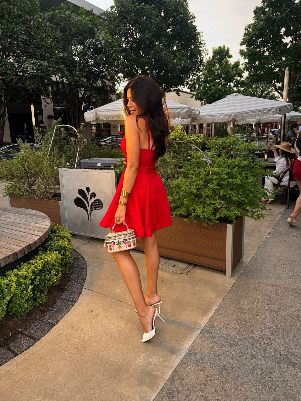 A Bright Red Mini Dress with White Heels and a Playful Embroidered Bag