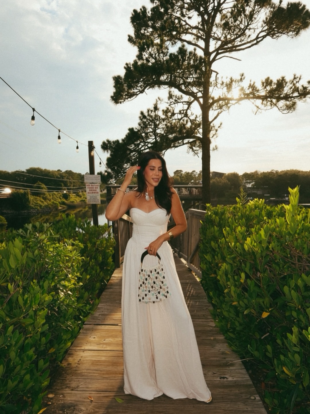 A Strapless White Wide-Leg Jumpsuit for an Elegant Sunset Evening